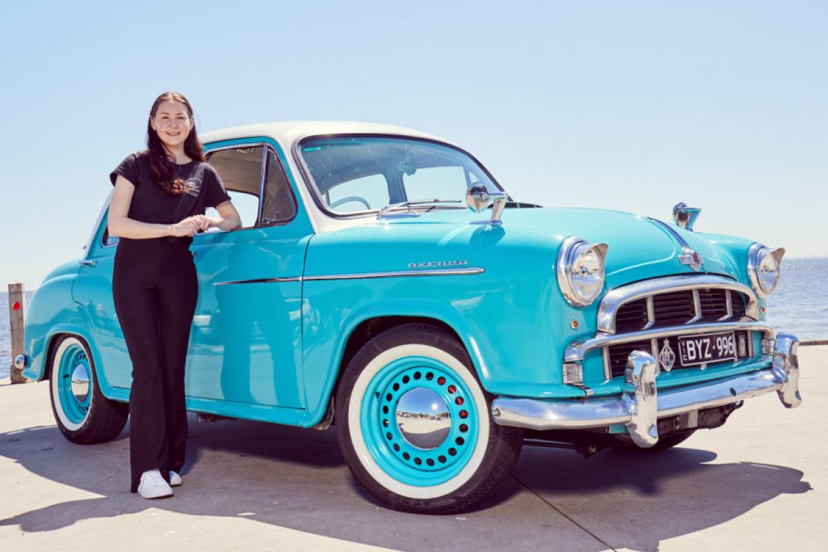 Kate Dawson in front of blue Morris Oxford