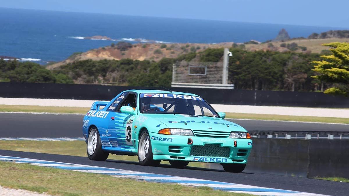 A light blue Nissan GTR on a race track