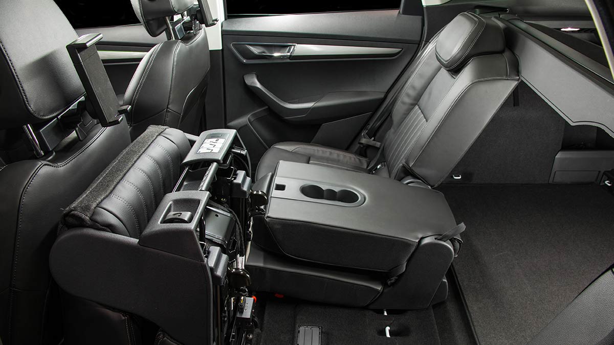 Dark grey interior of the Skoda Karoq 2019 showing the rear seats, one of which is folded down