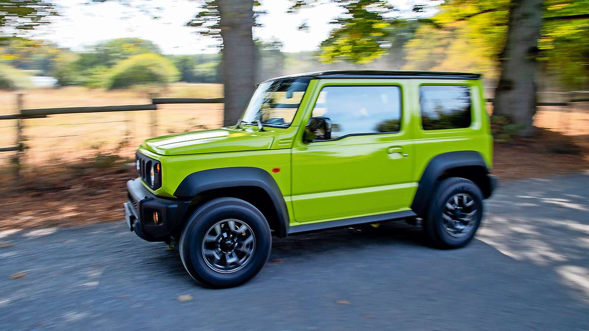 Side view of a lime green Suzuki Jimny 2019 in motion
