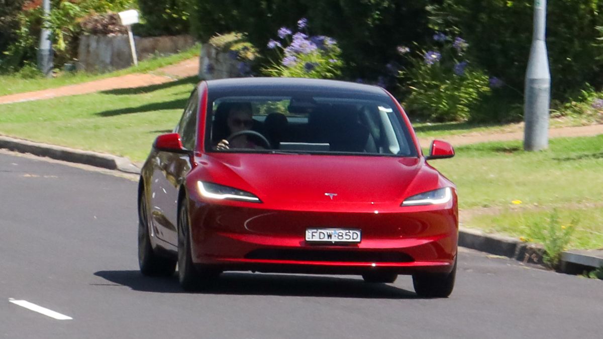Tesla Model 3 driving on road