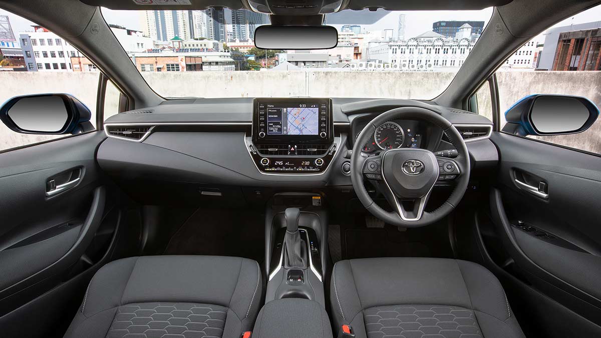 Interior of a Toyota Corolla 2018 car showing the grey dashboard and front seats