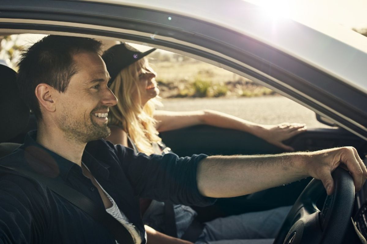 Young couple driving car
