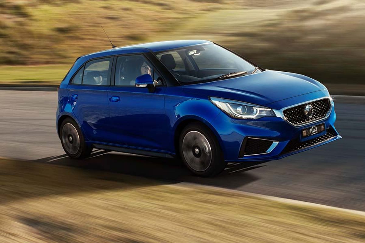 Close up image of blue MG3 Core driving on dusty country road