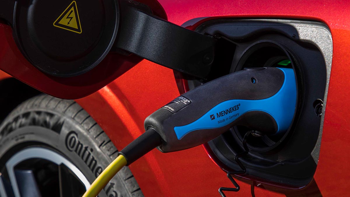 Close up of a charger plugged into a red Volvo S60 T8 R-Design 2020 car