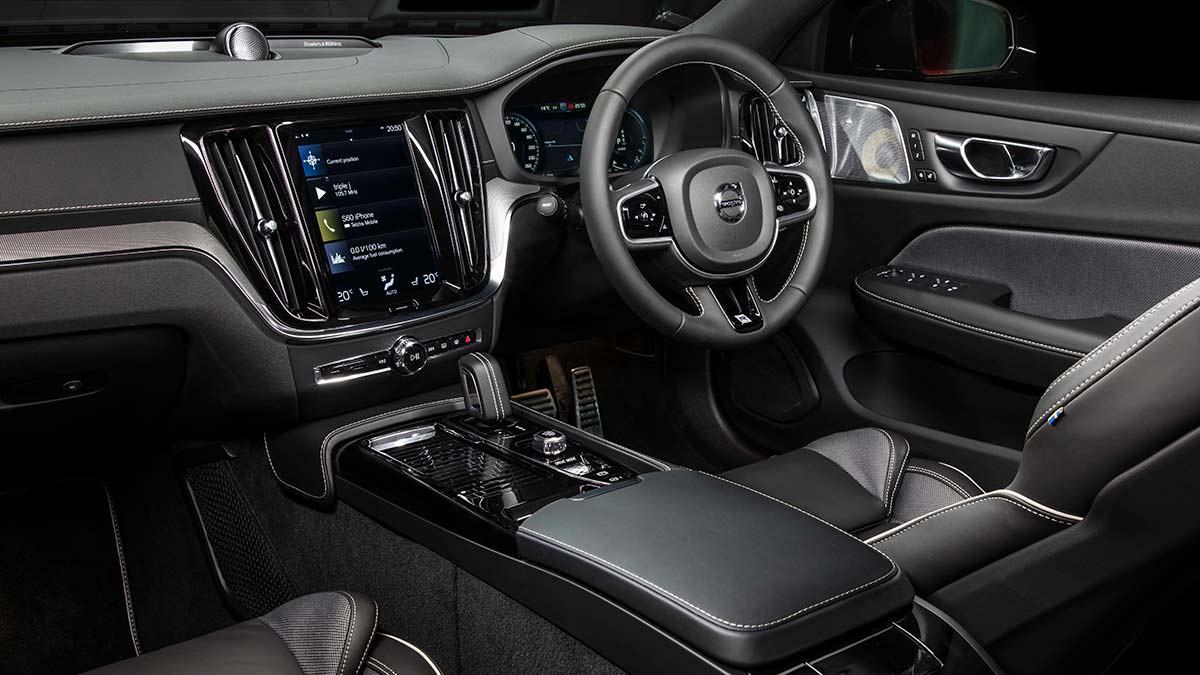 Dark grey and black interior of the Volvo S60 T8 R-Design 2020 showing the driver's seat, centre console and steering wheel