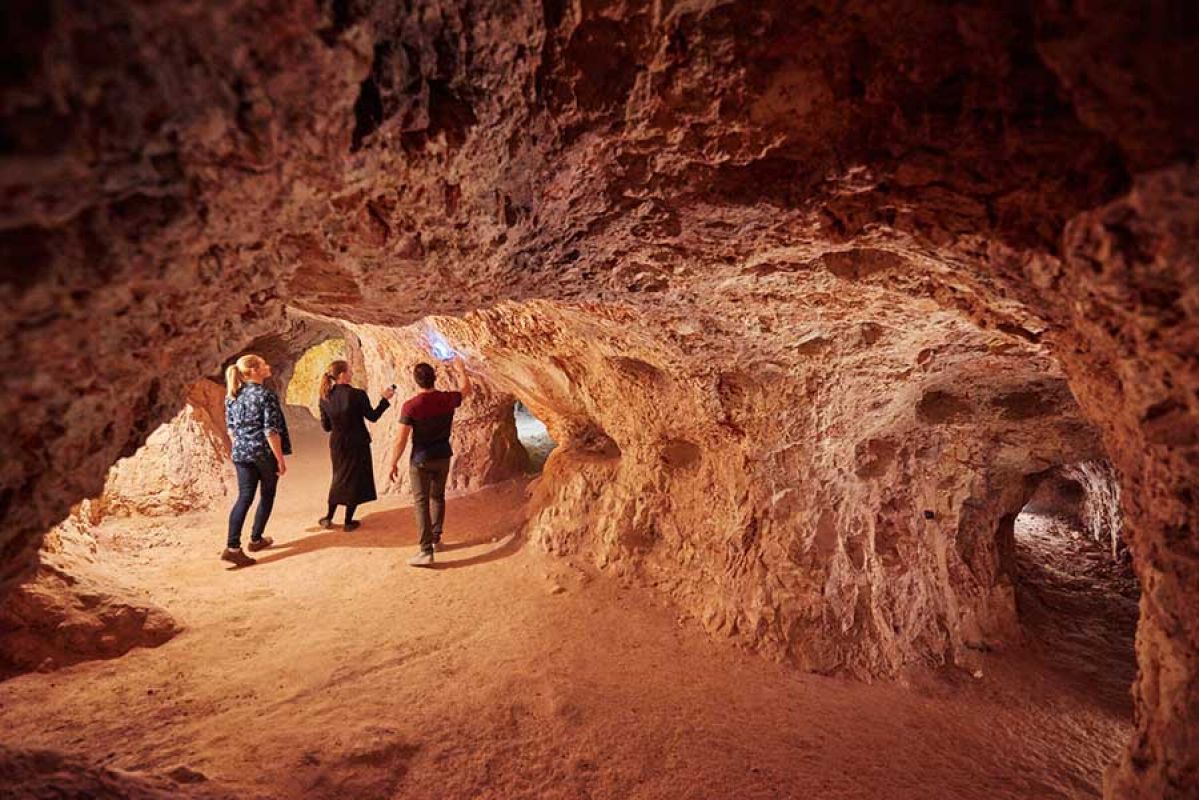 People walking through caves 