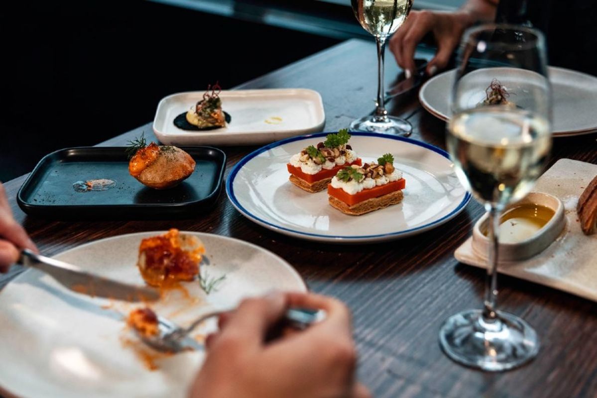Food and wine on a table at Movida Lorne