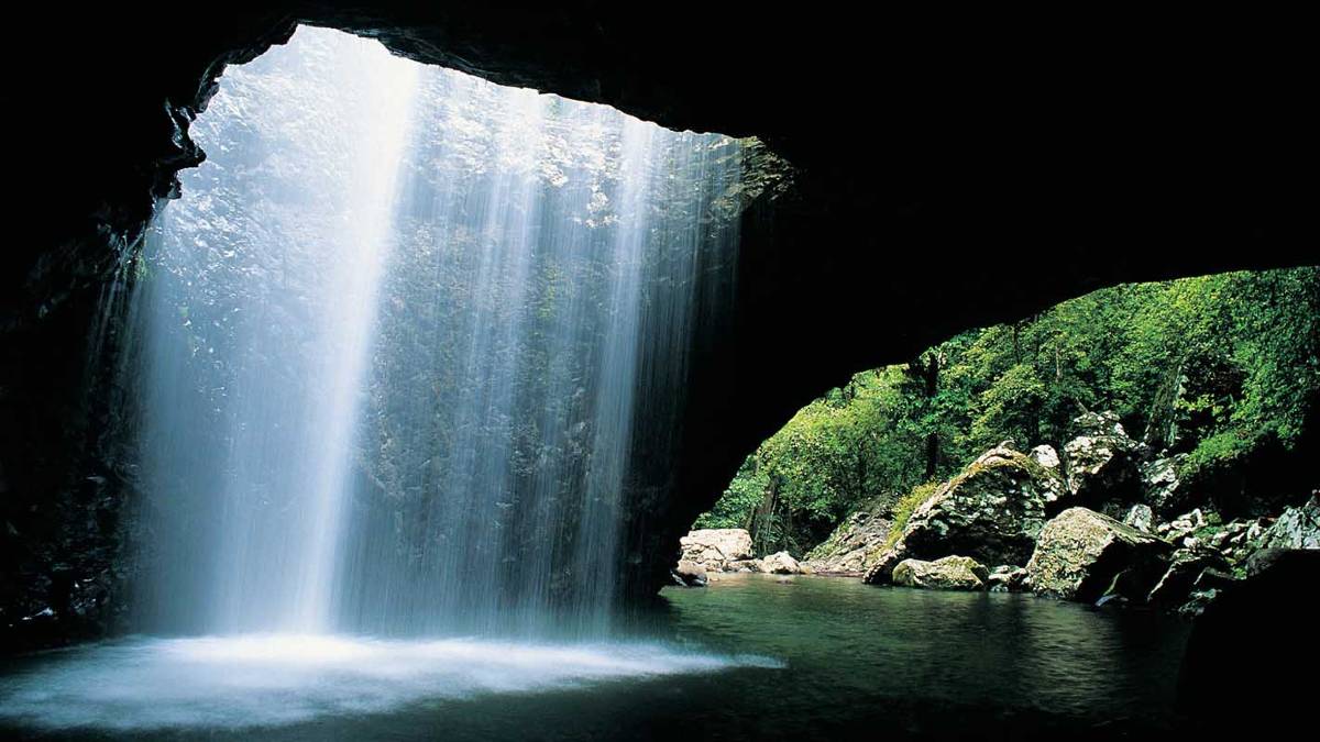 Light falling though to the water in cave