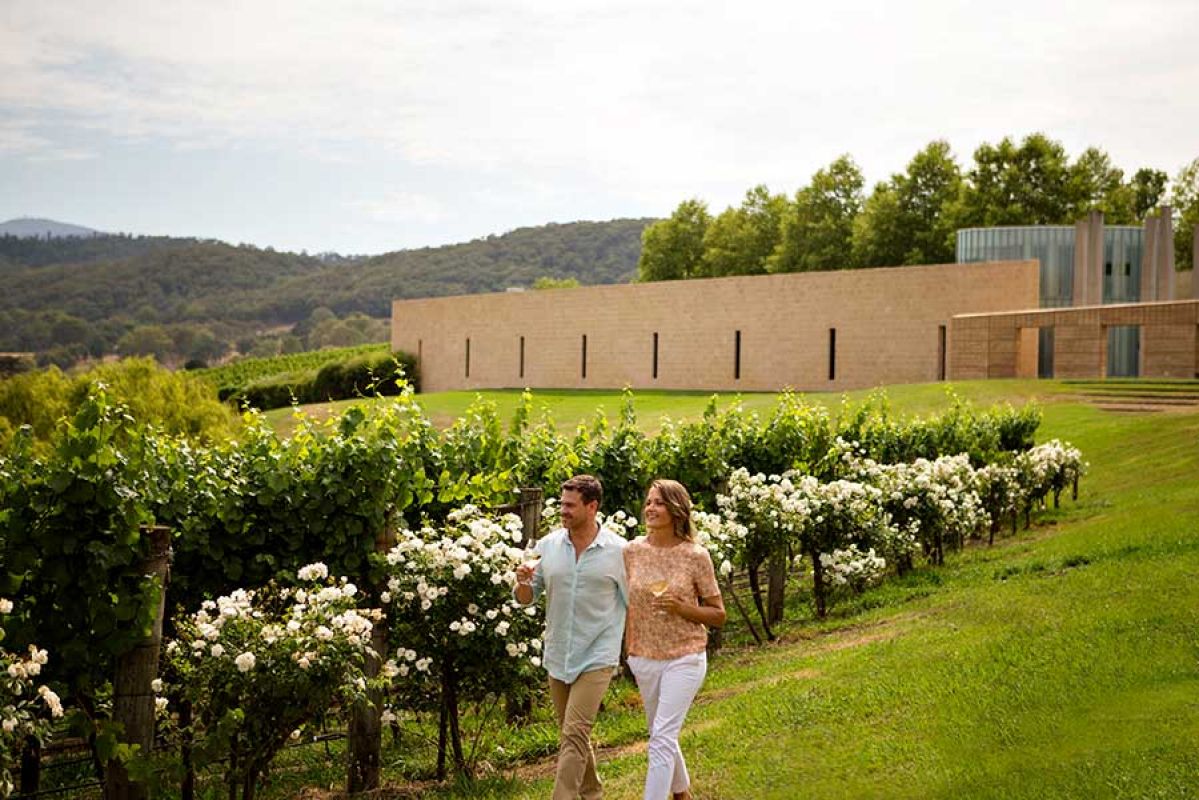 Couple walking through Tarra Warra estate, Yarra Valley 