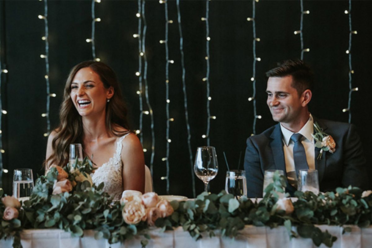 A couple sitting at a table after getting married