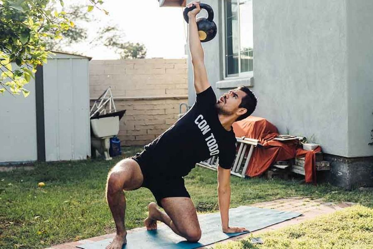 person exercising outside with a kettlebell