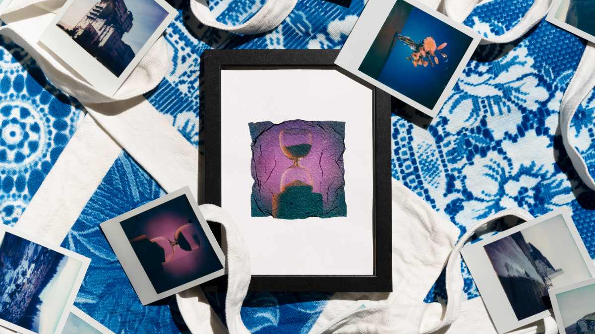 Various polaroid and framed photos on blue printed tote bags