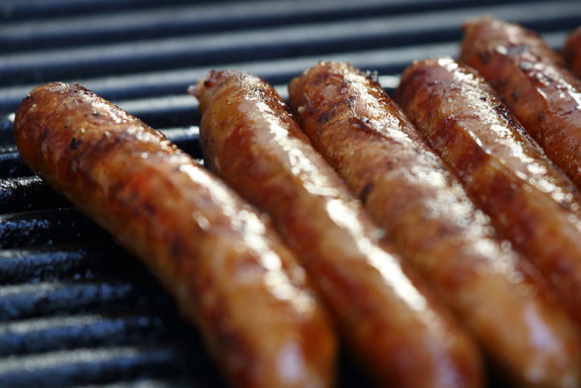 Close-up of sausages cooking on a BBQ grill