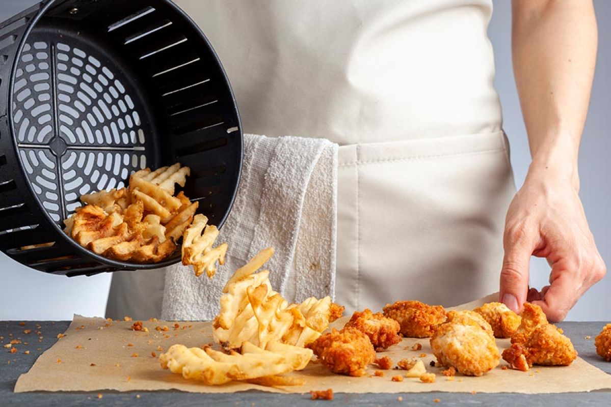 air fryer basket full of cooked potato