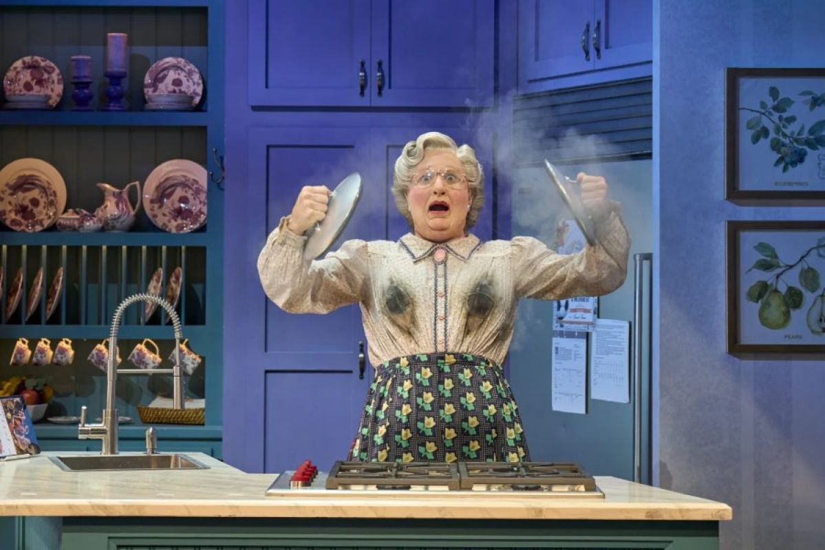Mrs Doubtfire gasping in kitchen with burned blouse holding pot lids