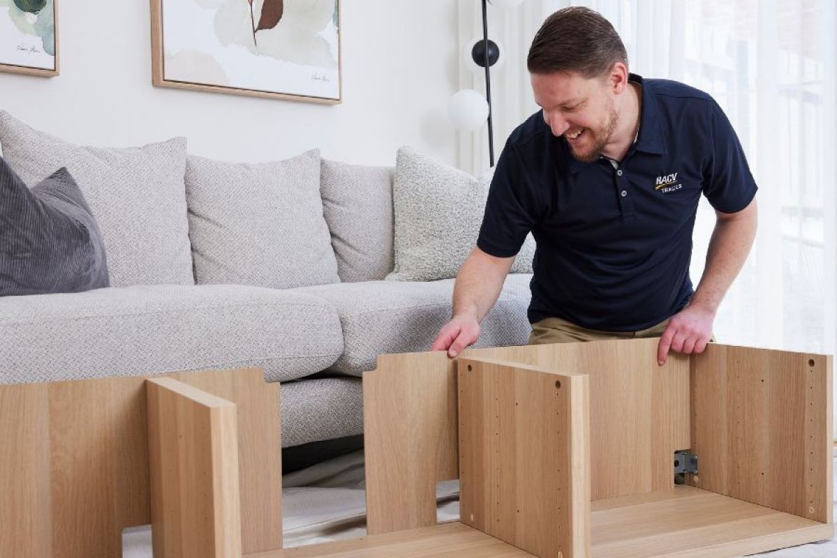 An RACV handyman putting together a piece of flat pack furniture