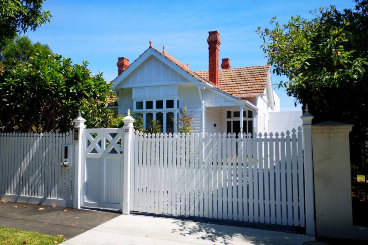 pretty Melbourne single-storey house with a chimney and white fence