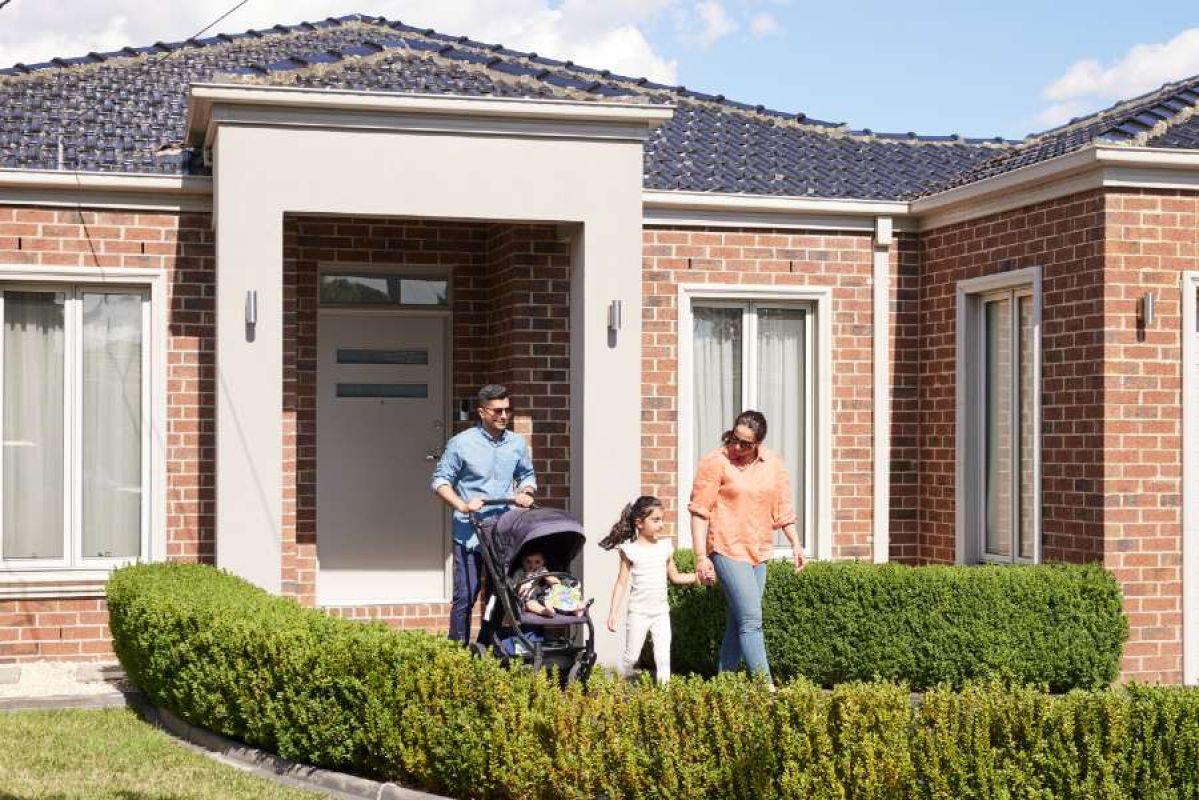 family walking out of their modern home