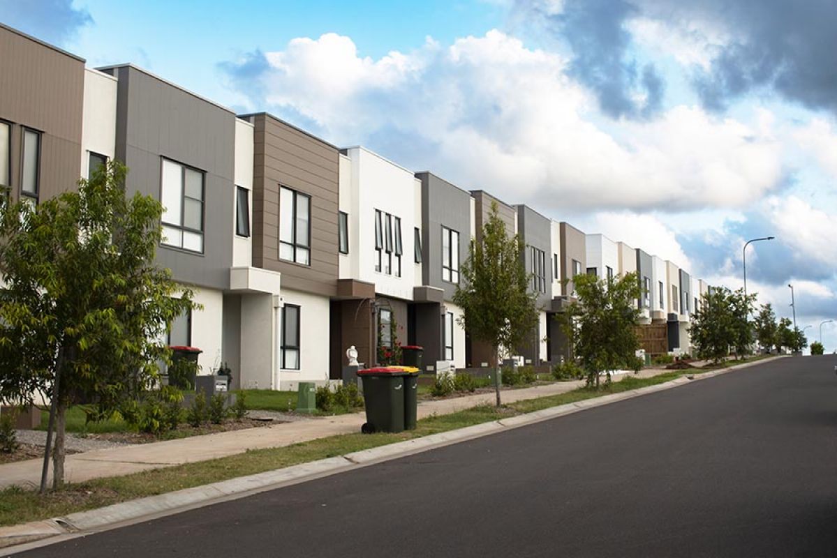 Row of modern two-storey townhouses with brown, grey and white facades