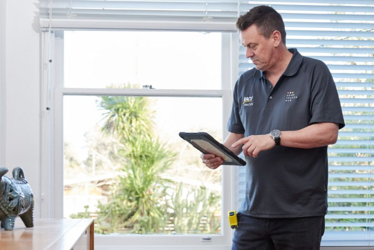 RACV Property Inspector looking at a tablet in a house