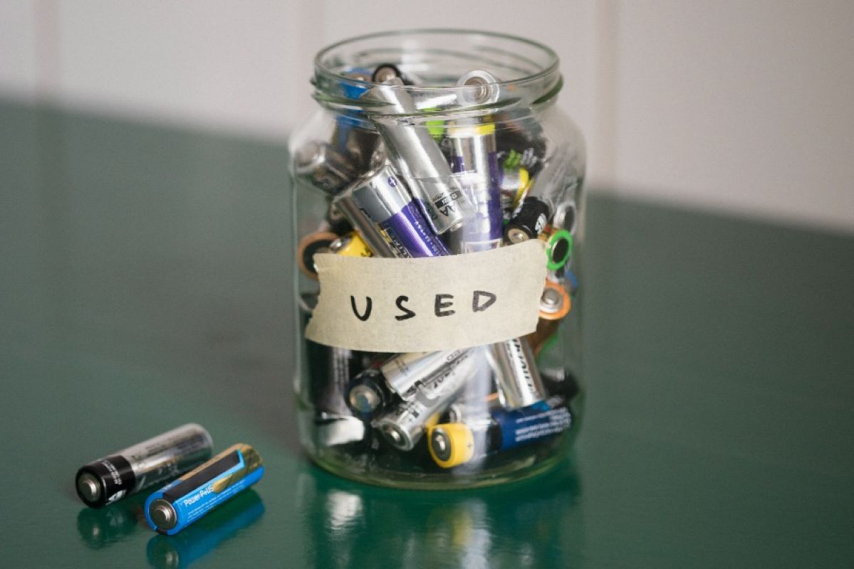 glass jar full of batteries; label reads USED