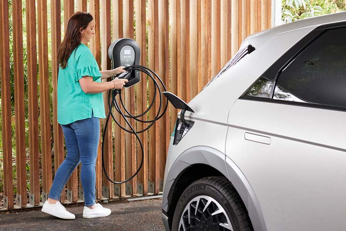 Tesla EV charger and Tesla car parked in garage