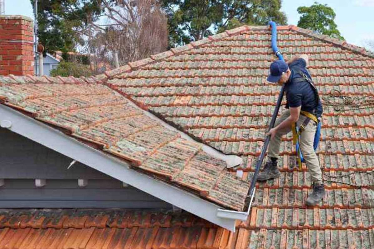 RACV tradie cleaning rooftop gutters