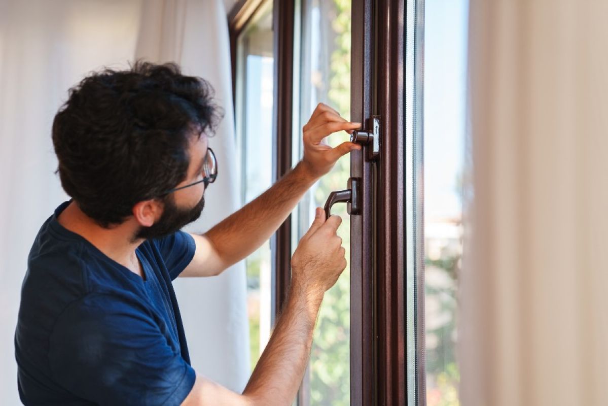 A man locking a window