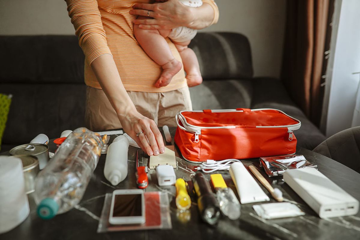 Man packing bag onto car carrier