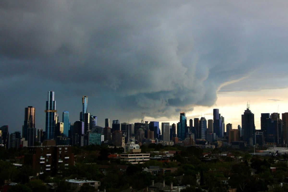 A huge, dark storm cloud looms over the Melbourne city skyline