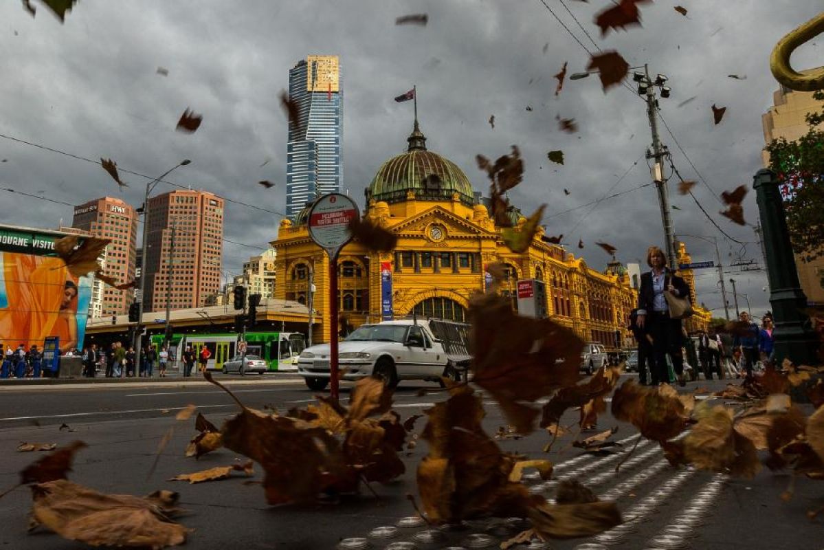 Flinders Street Station on a windy, stormy day with leaves blowing in the air