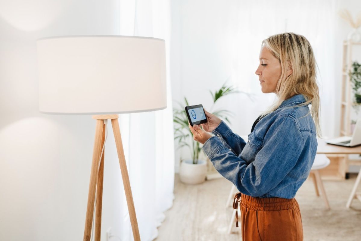 woman checking her household energy use in a smartphone app