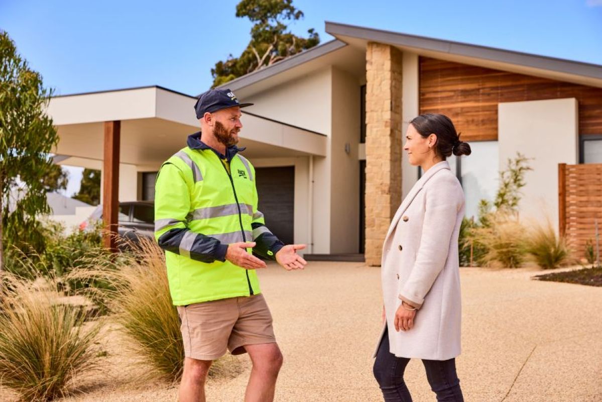 RACV Solar technician talking to homeowner outside her house