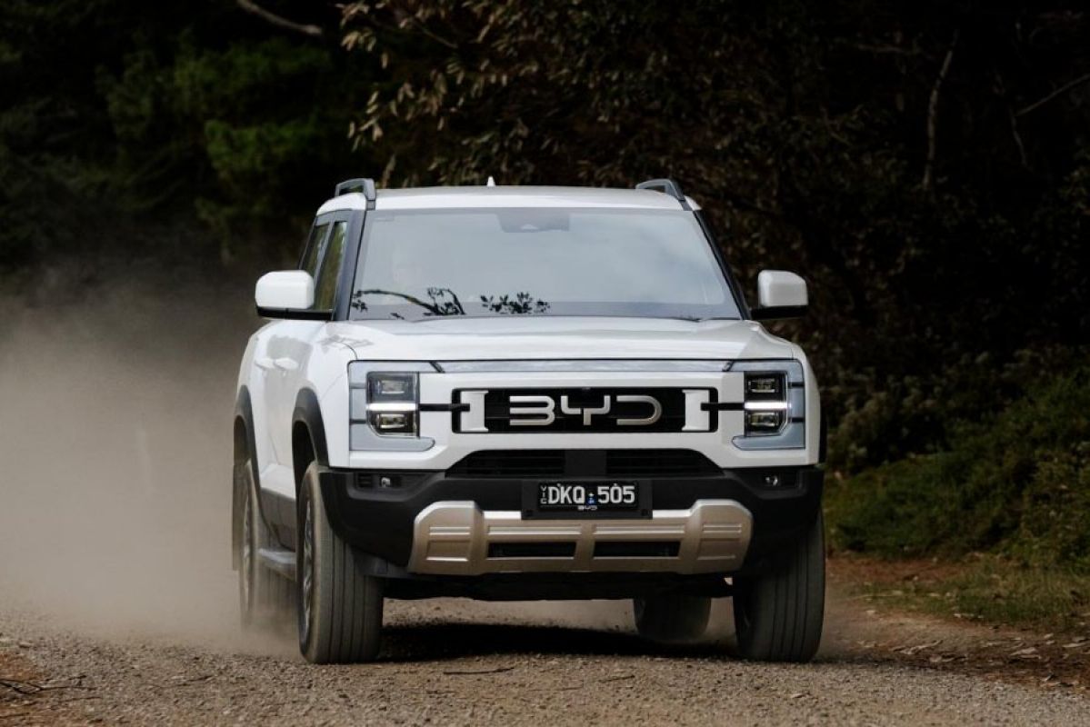 white 2025 BYD Shark 6 driving off-road