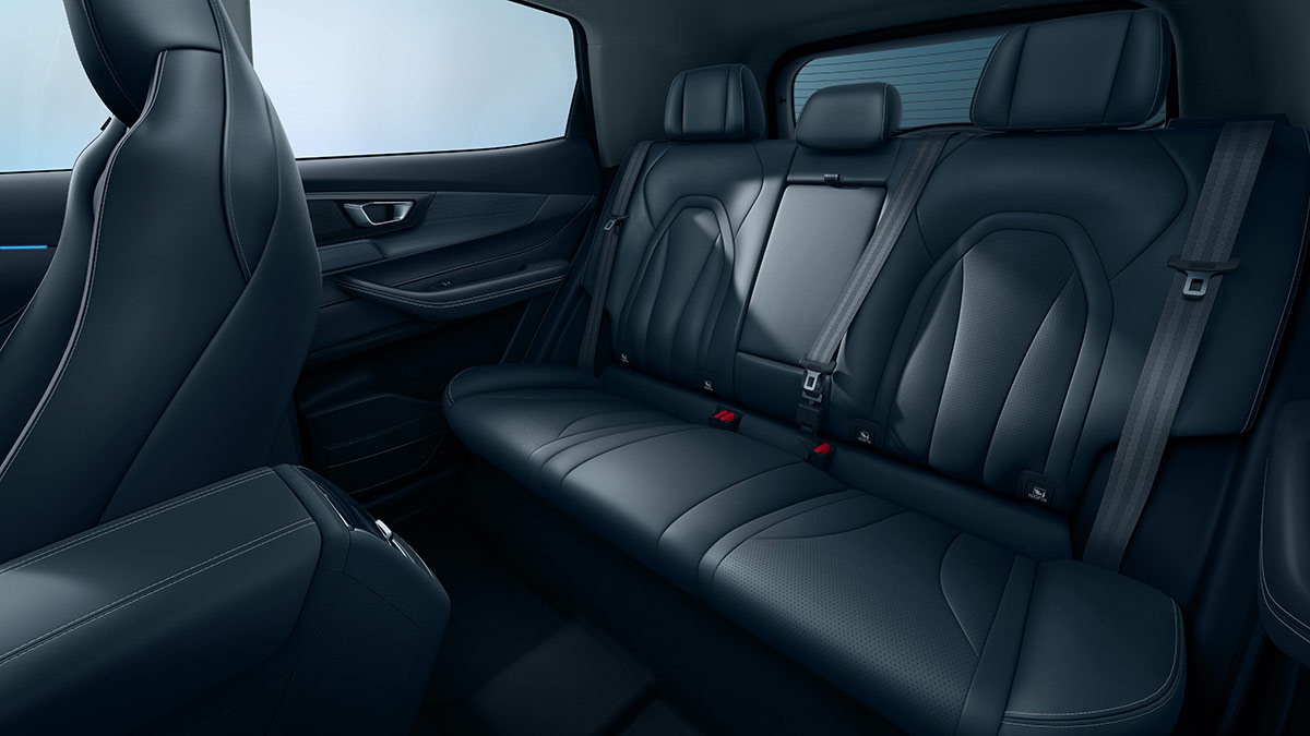Rear seat area of Chery Tiggo 4 Hybrid with dark grey premium trim and rear air vents behind centre console
