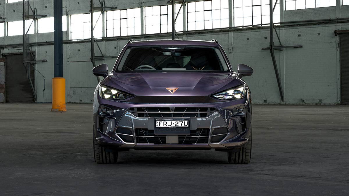 Frontal view showing large grille of purple Cupra Terramar VZ in warehouse