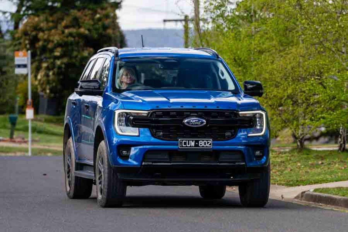 Blue SUV being driven along suburban street