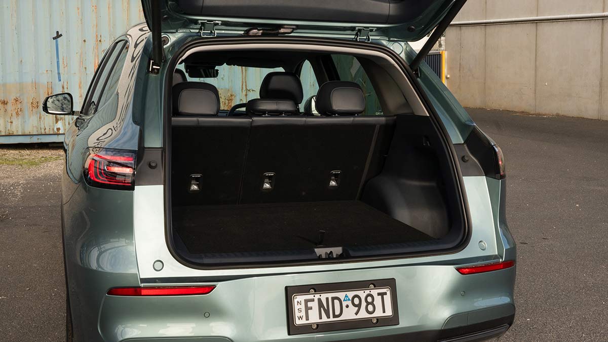 Tailgate open showing cargo area of grey-blue Geely EX5 Inspire medium SUV