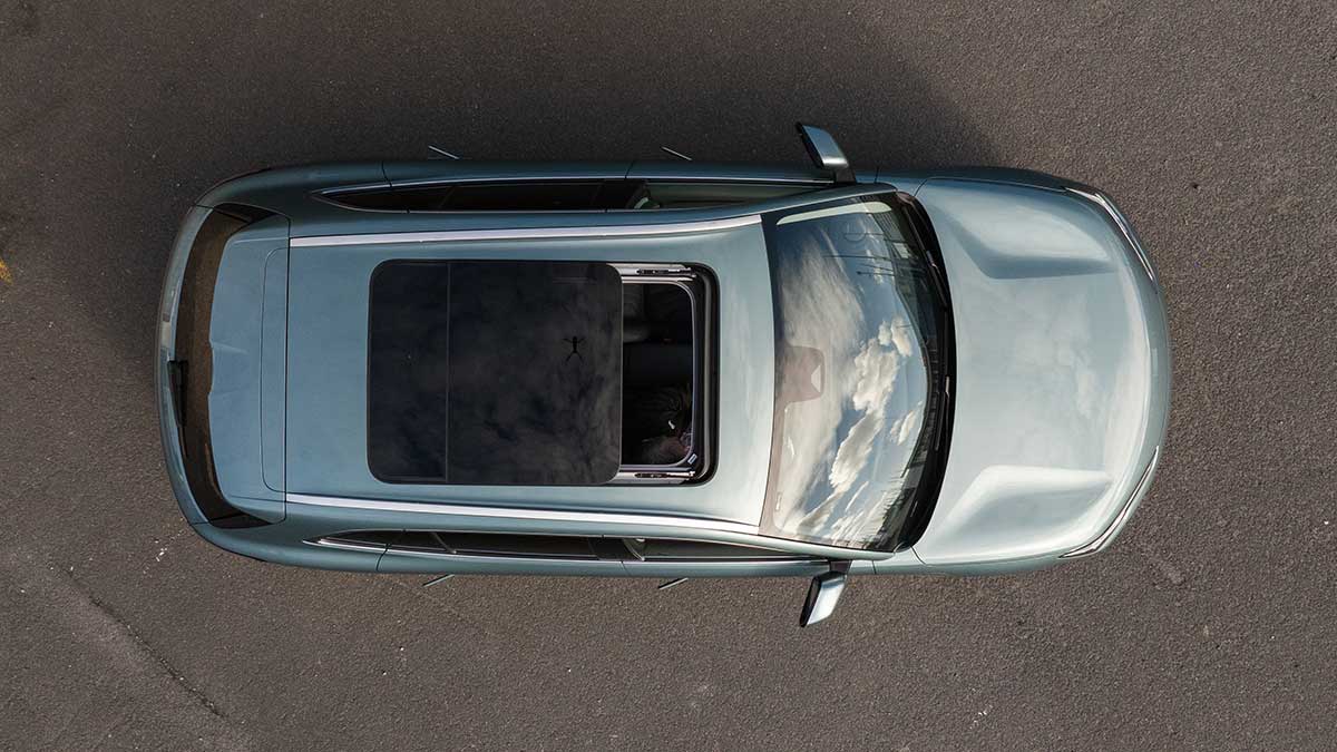 Overhead view showing large sunroof of grey-blue Geely EX5 Inspire medium SUV 