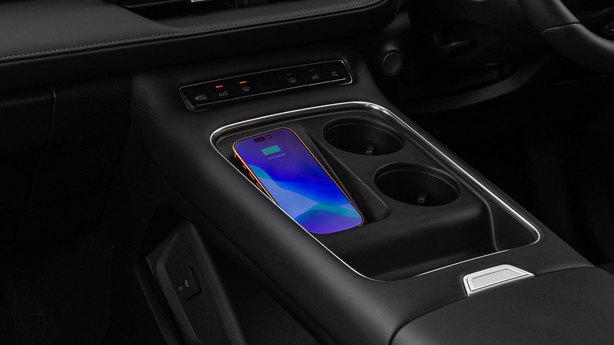 New centre console in GWM Haval H6 PHEV with phone resting in wireless charging pad.