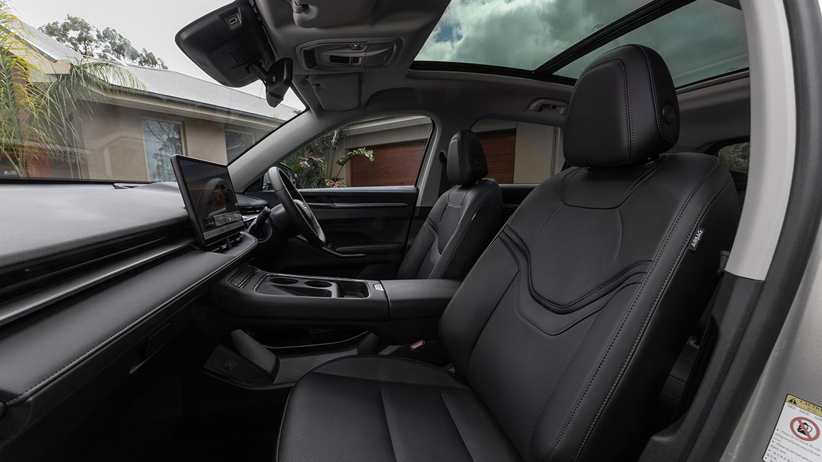 View into front seat compartment of GWM Haval H6 Ultra PHEV with minimalist layout and panoramic sunroof.