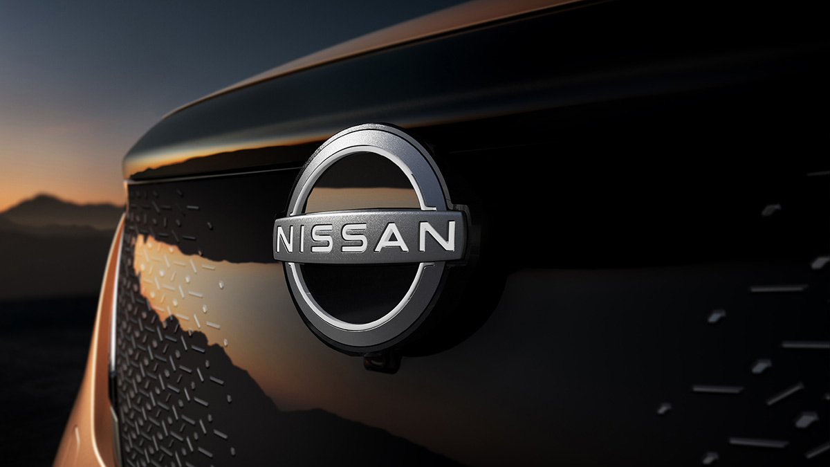 Logo and enclosed grille of copper-coloured Nissan Ariya medium electric SUV