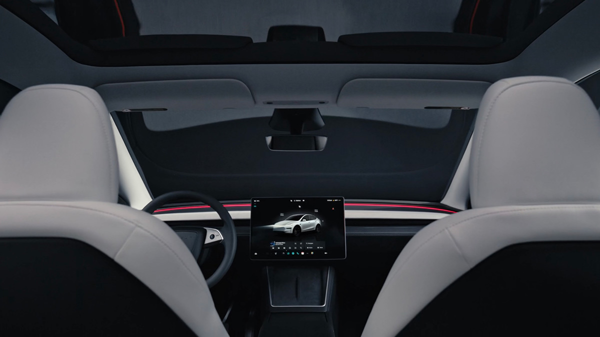 View of Tesla Model Y dashboard, seen from rear seat