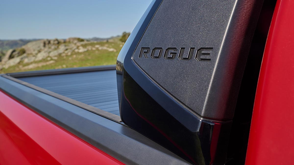 Red Toyota HiLux Rogue ute with black sports bar and black roller cover for load area.