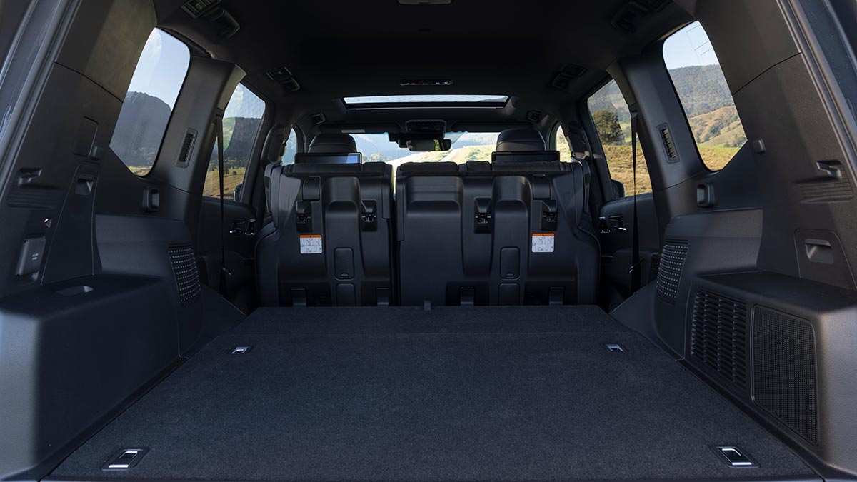 Cargo area of Toyota LandCruiser Sahara ZX Hybrid SUV with rear seats folded and tumbled forward.