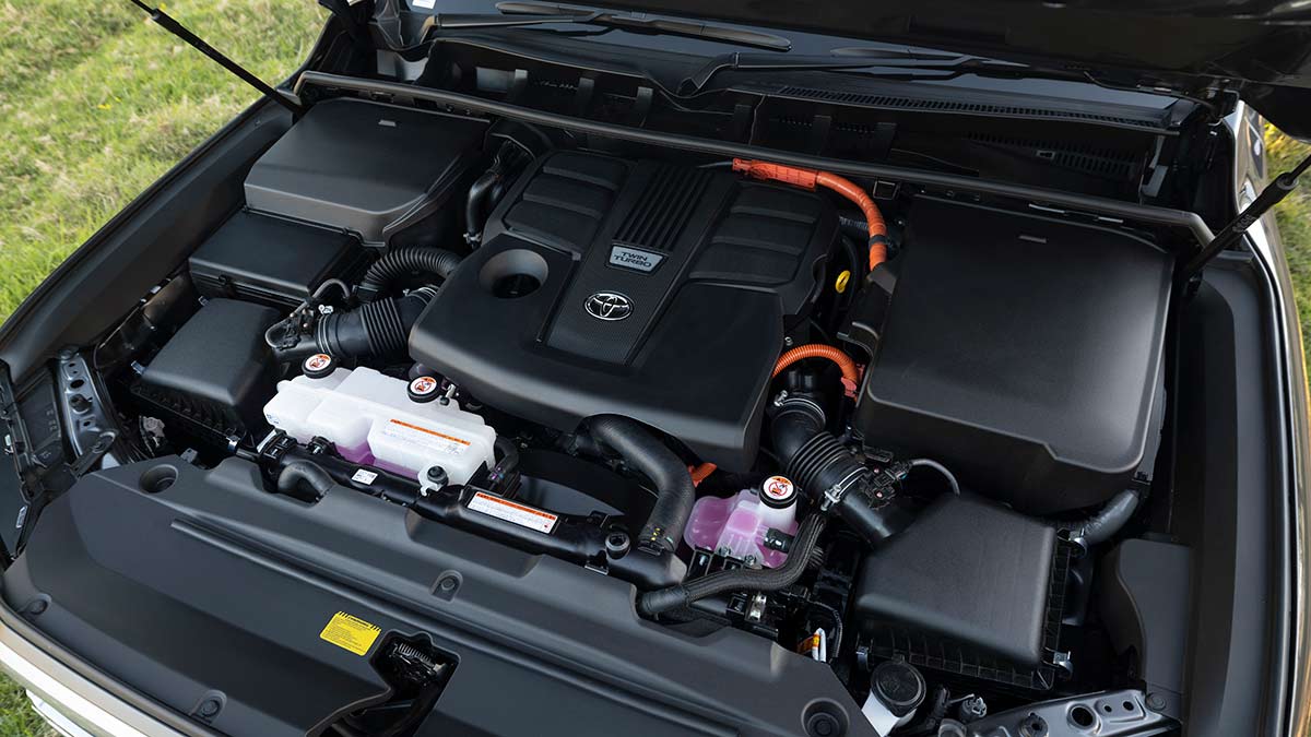 Overhead view of hybrid powertrain under bonnet of Toyota LandCruiser Sahara ZX SUV.