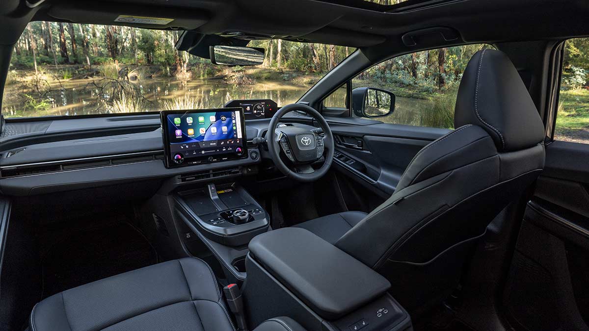 Cockpit area in Toyota bZ4X Touring SUV with dark trim and dual digital screens for the driver.