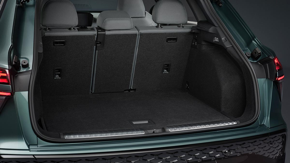 Cargo area of sage green Audi Q3 small SUV with dark cabin trim and contrastinglight grey seat trim and dark 