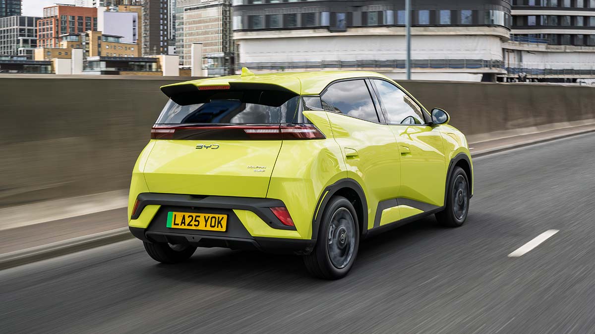 Rear shot of lime green BYD Atto 1 EV hatch on UK city arterial road. 